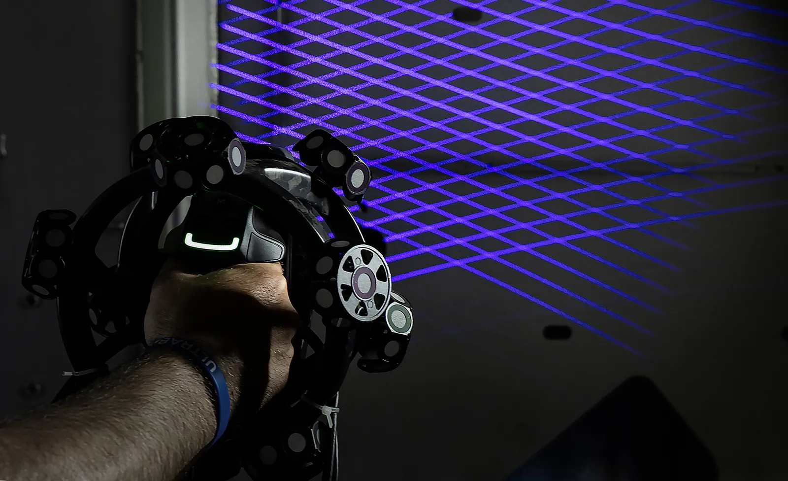 Handheld 3D scanner measuring a welded part against its CAD model